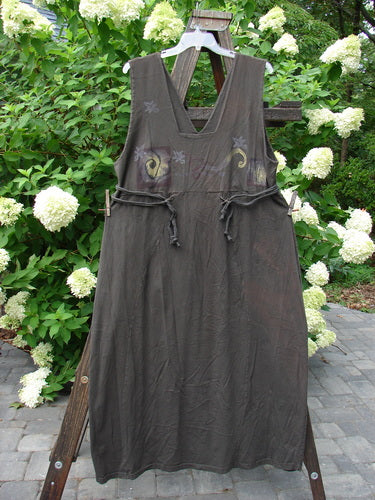 1994 Scroll Jumper Wind Edo Black OSFA displayed on a wooden structure outdoors, showcasing its unique V-shaped neckline, double-paneled upper bodice, and wide, flowing lower skirt.