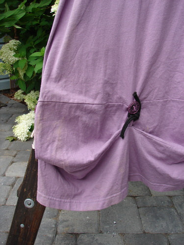 Close-up of the 1997 Salt Water Taffy Jumper Summer Ocean Jasmine Size 2 featuring front pockets, clear textured buttons, and rippie accents, showcasing organic cotton craftsmanship and intricate details.