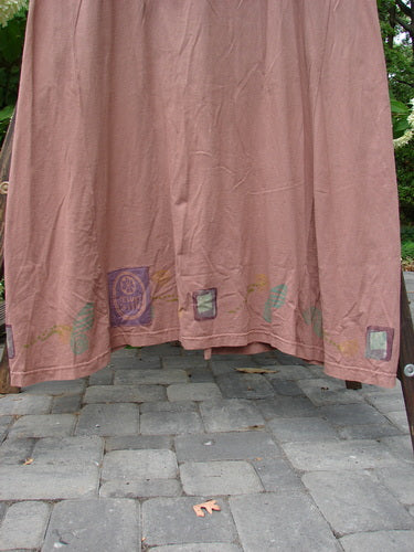 1993 Sleeveless Jumper Vest Sweet Pea Dried Rose OSFA displayed on a stone floor, showcasing deeper arm openings, a scooped neckline, unique ceramic and dual color buttons, and a sweet pea theme.