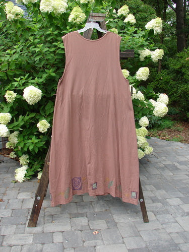 1993 Sleeveless Jumper Vest Sweet Pea Dried Rose OSFA: A dress on a clothes rack with deeper arm openings, a longer A-line sweep, and unique ceramic and taganut buttons.