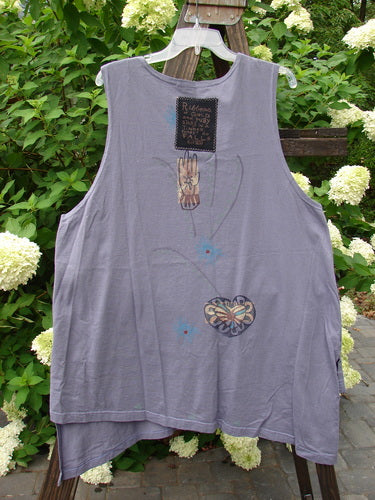 Image: A grey tank top with a graphic design on it, from the 1996 Seeker's Vest Heart Mulberry OSFA collection. Made from Mid Weight Organic Cotton. Features include A Line Shape, Deep V Neckline, and Abstract Heart Theme Paint. Blue Fish Patch Center back and Original Blue Fish Buttons. Bust 52, Waist 54, Hips 60, Front Length 32, Back Length 38.