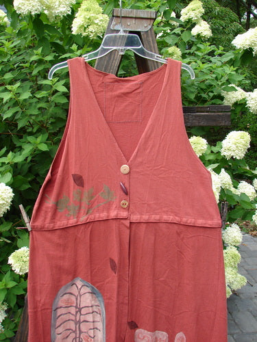 1993 Little Tree Vest Falling Leaf Red Oro OSFA displayed on a wooden swing, showcasing its unique snap-off panel, shimmering harvest theme, and vintage buttons against an outdoor backdrop.