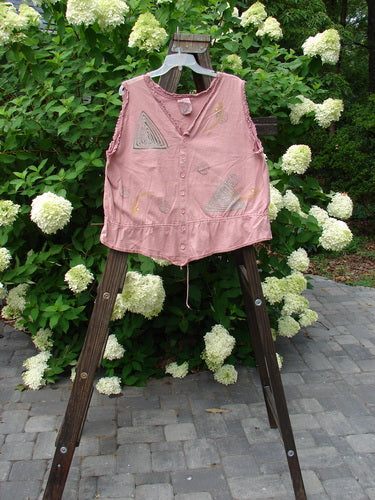 1995 Wish Vest Ocean Shell Heart Size 2 displayed on a wooden stand, featuring a V-shaped neckline, antique lace accents, adjustable hemline, and whimsical ocean-themed paint, embodying a true peasant look.