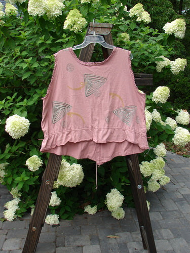 1995 Wish Vest Ocean Shell Heart Size 2: A pink shirt on a wooden stand with antique lace accents. Floral design and outdoor vibes.