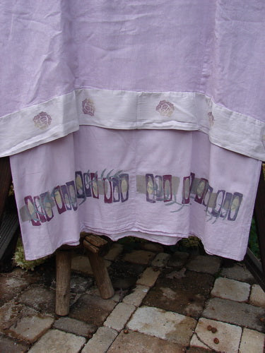 Barclay Linen Crossover Two Tier Dress Floral Lavender Size 2 features a double-layered flow, V neckline, wide cuffs, and floral design, showcasing a unique downward curved empire waist seam and interior side pockets.