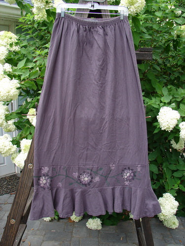 1996 Spring Laughter Skirt Vine Blossom Violet Field Size 2 displayed on a wooden rack, showcasing detailed floral design and full elastic waistband, made from organic cotton.