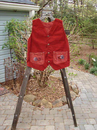 1997 Contractor's Vest in Brick, perfect condition. Dense cotton rear, corduroy front. Metal stamped buttons, accent buckle back, adjustable strap. Angular painted home pockets with metal rivets. Square boxy shape, V neckline, sectional panels. Bust 42, waist 48, hip 48. Front length 27, back length 23.