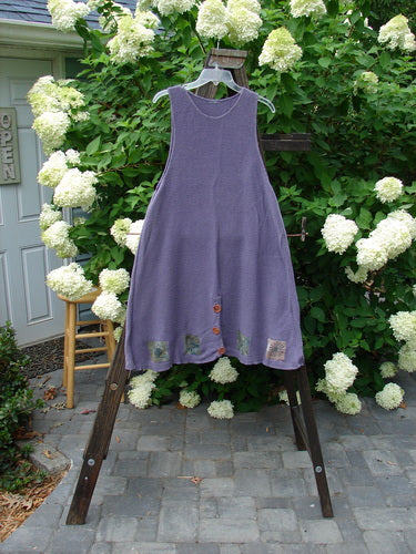 1994 Vent Vest Sweater Jumper Sea Life Periwinkle OSFA displayed on a wooden rack, showcasing its knitted texture, clay buttons, and detailed hemline for a slenderizing look.