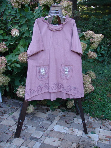 Barclay Linen Duet Sunrise Dress Tiny Floral Dusty Rose Size 2 features a ruffled collar, three-quarter sleeves, and floral-embroidered pockets on a wooden stand, embodying vintage charm and individuality from Bluefishfinder.com.