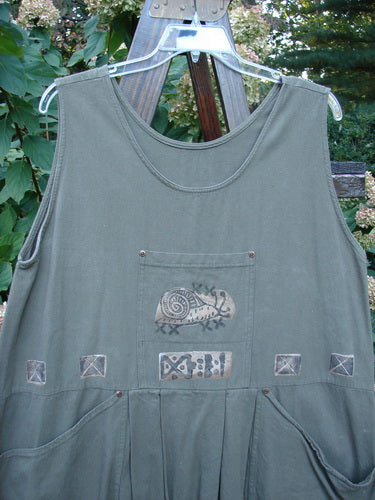 1995 Invention Smock The Garden Snail Bramble OSFA features front pleats, a bib pocket, whimsical snail drawings, side pockets with rivets, and a back tunnel pocket, showcasing vintage Blue Fish style.