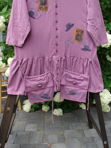 1997 Belladonna Jacket Fancy Hat Crocus Size 1: A purple dress with pockets, featuring detachable pocket purses, textured knotted buttons, whimsical top hat theme paint, and a flirty bottom flounce.