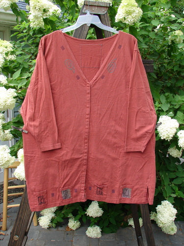 1993 Sticks and Stones Jacket Windy Day Red Oro OSFA displayed on a rack, featuring a deep V neckline, front snaps, vented sides, and painted pockets.