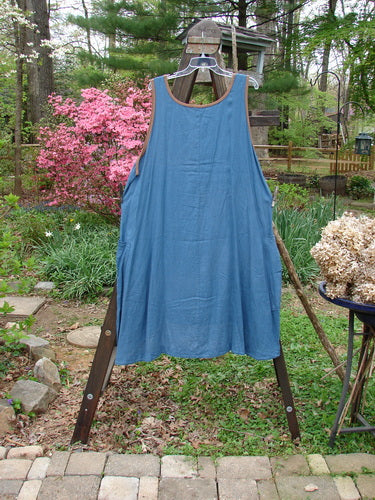 Barclay Linen Contrast Pocket Jumper Unpainted Deep Teal Size 2 displayed on a rack, showcasing its rounded neckline, deeper arm openings, front wrap drop pockets, and sectional lower panel.