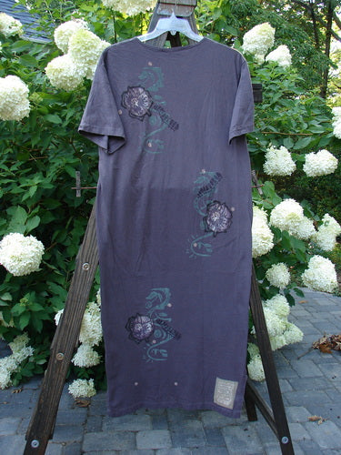 1996 Long Tea Dress Curl Rose Violet Field Size 1: A straighter cut dress with a vibrant, hand-painted curl rose theme. Features a scooped neckline and tapered bottom line with side vents. Made from medium weight organic cotton. Bust 42, waist 42, hips 42. Length 54 inches.