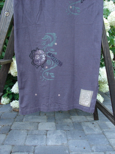 1996 Long Tea Dress Curl Rose Violet Field Size 1: A purple towel with a flower design on a wooden frame.