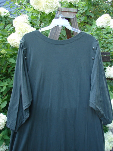 1994 Convertible Coat Spin Flower Deep Moss OSFA displayed on a hanger, showcasing its versatile button-off sleeves and unique upward scooped hemline, emphasizing its collectible, vintage appeal.