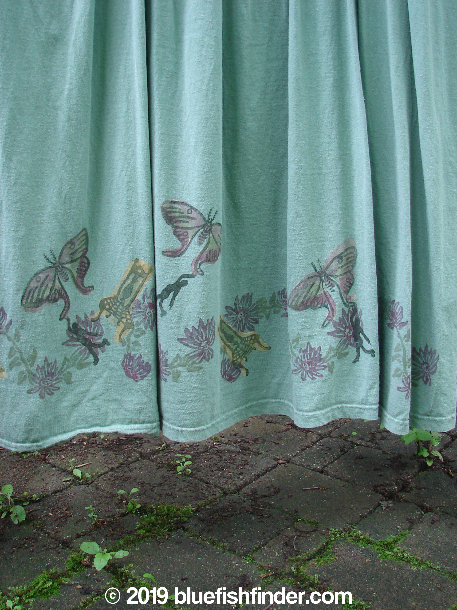 Image alt text: 1994 Side Button Jumper Butterfly Garden River Size 1 - A curtain with butterflies and flowers, featuring a close-up of a stone surface, a painting, and a fabric with a person and flowers.