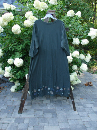 1994 Convertible Coat Spin Flower Deep Moss OSFA displayed on a rack, highlighting its unique button-on/off sleeves and upward scooped front hemline, embodying versatile and artistic design features.