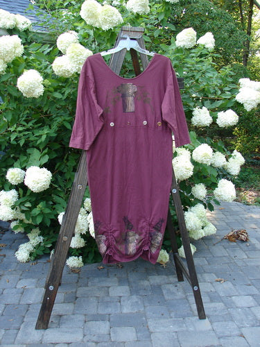 1993 Deep Neck Button Dress Woodberry Roman Strings OSFA displayed on a wooden rack, showcasing its deep neckline, empire seam button accent, and three vertical bottom interior draw cords.