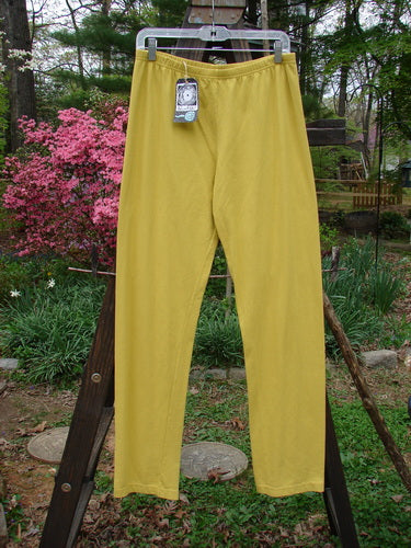 Barclay NWT Cotton Lycra Bally Layering Pant Legging Unpainted Goldenrod Size 2: A pair of yellow pants on a wooden pole, perfect for casual wear.
