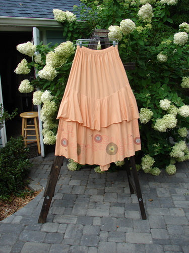Barclay Two Story Skirt Bubbles Sherbert Size 2 on a rack, showcasing a frilled, bubble-themed design with a full elastic waistline and dual-layered organic cotton fabric.