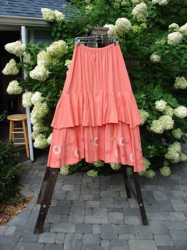 Barclay Two Story Skirt Bubbles Tangerine Size 2, featuring a full elastic waistline and frill, displayed on a rack.