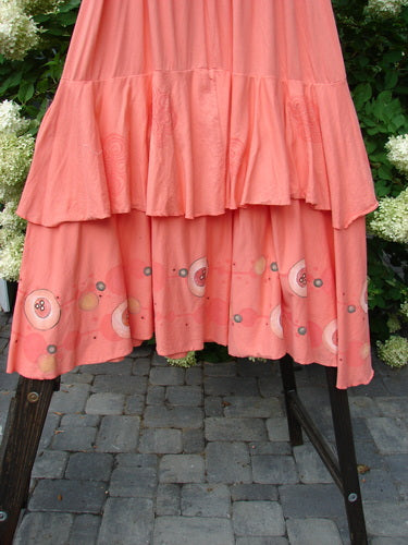 Barclay Two Story Skirt Bubbles Tangerine Size 2 displayed on a stand, showcasing its full elastic waistline, flutter edges, and bubble-themed design.