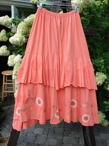 Barclay Two Story Skirt Bubbles Tangerine Size 2 displayed on a rack, showcasing the floral design, full elastic waistline, and varying ruffled edges.