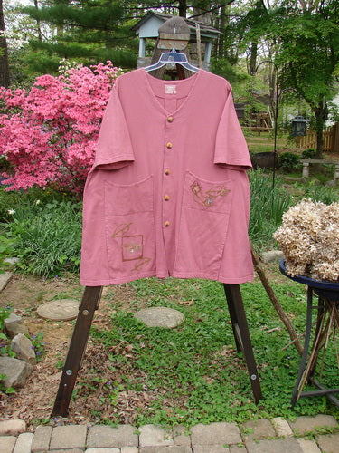 2000 Double Decker Pocket Top Garden Bug Rose Size 2 displayed on a stand, highlighting its pleated back, two front oversized pockets, and signature Blue Fish Patch.