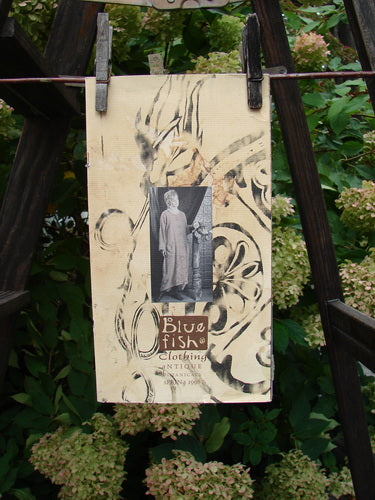 1998 Spring Catalog Antique Botanicals One Size displayed on a clothesline, highlighting vintage images, botanical art, and poetry. Ideal for identifying vintage Blue Fish Clothing pieces or for nostalgic reminiscence.