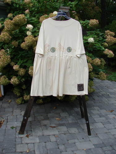 1999 NWT Vintage Button Dress Stone Skip Natural Size 2 displayed on a rack, featuring 11 tiny buttons down the front, three larger buttons at the waistline, and two higher-placed pockets.