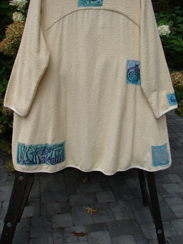 1996 Patched Cape Cod Coat with farm-themed patches and a single button closure.
