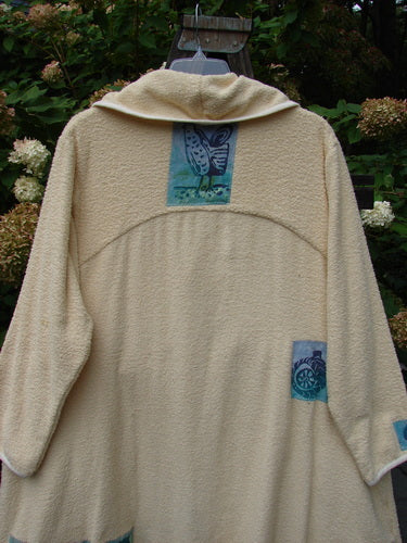 1996 Patched Cape Cod Coat with Farm Theme Patches and Blue Fish Patch, made from French Cotton Terry Cloth. Oversized front pockets, single button closure, deep V-necked collar, and rolled piping on edges.