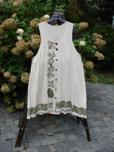 1993 Long Column Vest Feather Fern Tea Dye OSFA displayed on a rack, showcasing deeper arm openings, a widening lower sweep, a deep oval neckline, and vintage buttons with a feather and fern theme.