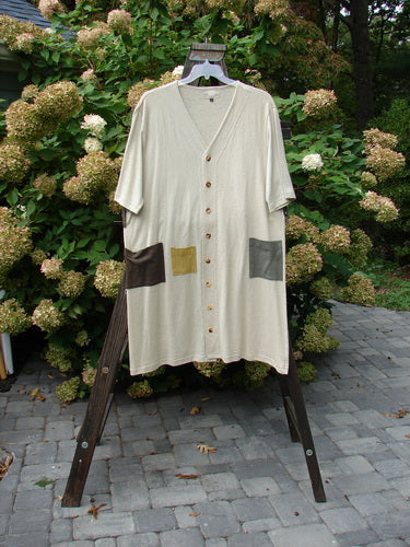 2000 Cotton Hemp 3 Block Cardigan Unpainted Dove Size 2 hanging on a rack, showcasing a V neckline, tri-colored accents, three front pockets, and original buttons.