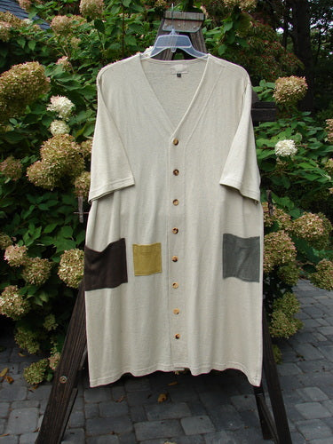 2000 Cotton Hemp 3 Block Cardigan Unpainted Dove Size 2 displayed on a hanger, featuring a V neckline, colorful painted pockets, and original Blue Fish buttons, showcasing its durable and soft hemp-cotton blend.