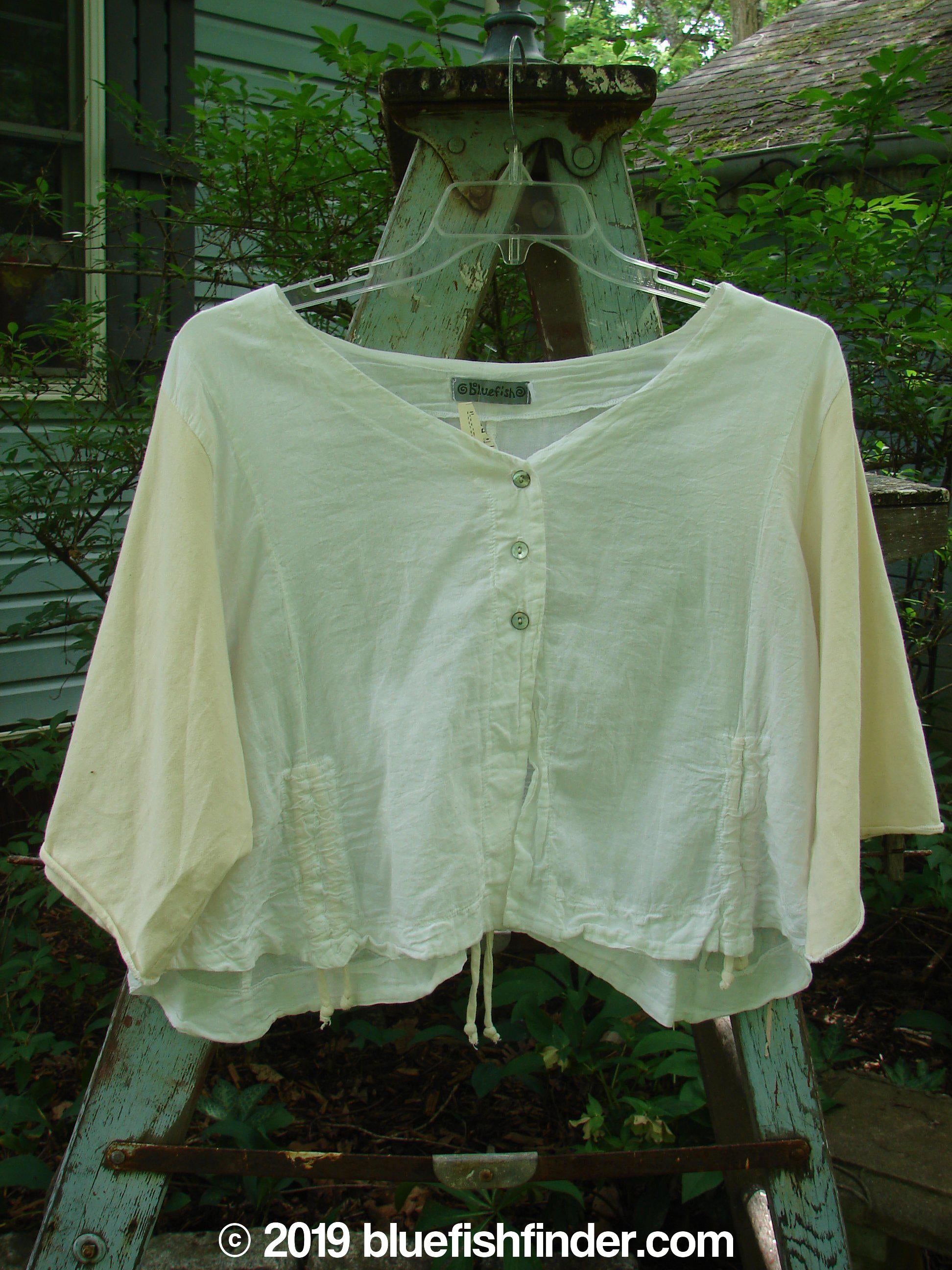 A white shirt on a swinger, part of the Barclay NWT Batiste Draw Midi Meadow Trio in White. Features include a wider boxier crop shape, three-quarter length cotton sleeves, and a wider neckline. The image showcases the shirt's design and style.