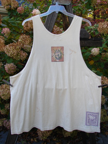 1999 Tank Top Dragonfly Beetle Dust Size 2: White organic cotton tank top with a colorful beetle design and signature Blue Fish patch, featuring a scooped neckline and boxy shape.