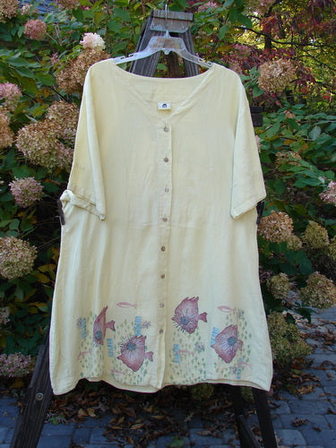 Barclay Linen Flower Button Gather Back Tunic Dress - A white shirt with fish design and a pig painted on it. Features a close-up of a button.