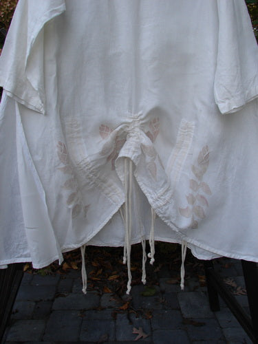 Barclay Linen Venetian High Vent Tunic Dress Tall Bud White Size 2, featuring a square neckline, tassel details, and flowing A-line shape, highlighting its feminine hourglass silhouette and triple front draw cords.