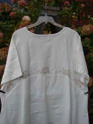 Barclay Linen Urchin Tunic Dress Undersea White Size 2 displayed on a swinger, featuring a rounded neckline, A-line shape, downward curved empire waist seam, wide short sleeves, and undersea-themed design.
