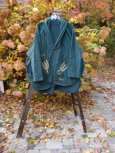 1996 Reprocessed Phoenician Jacket Holiday Fern Viridian OSFA displayed on a rack, highlighting its dense cotton, double button hole, drop shoulders, dolman sleeves, and signature Blue Fish Patch.