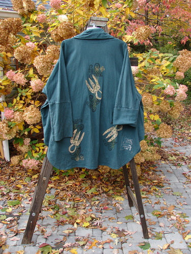 1996 Reprocessed Phoenician Jacket Holiday Fern Viridian OSFA displayed on a stand, featuring drop shoulders, dolman sleeves, deep V neckline, and oversized pockets, with a flowing and rounded hemline.