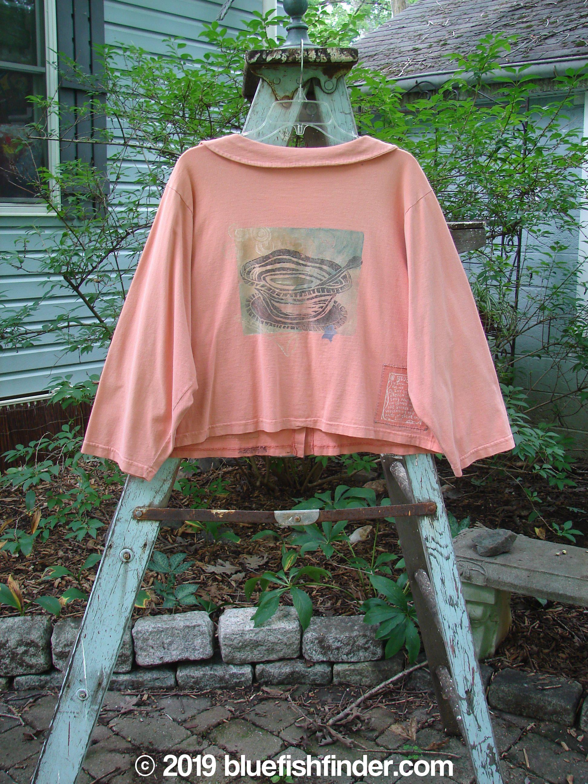 Image alt text: "1994 Box Pocket Jacket in Reef, featuring a pink jacket with a unique collar, oversized front pockets, and vintage buttons. Cropped and boxy shape with Blue Fish patch and 1994 paint."
