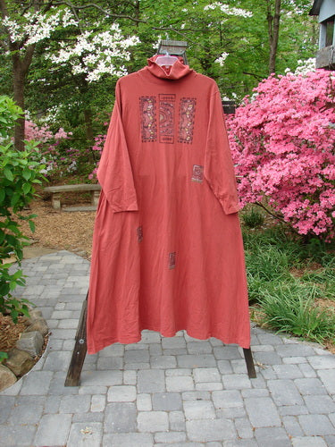 1995 Omega Dress Triple Path Red Glaze Size 1 displayed on a rack, featuring a generous turtleneck, drop shoulders, deep side pockets, and an A-line flare with a drawcord backline.