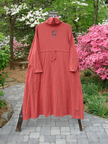 1995 Omega Dress Triple Path Red Glaze Size 1 showcased on a rack, featuring a heavy ribbed turtleneck, drop shoulders, two deep side pockets, and a drawcord backline.