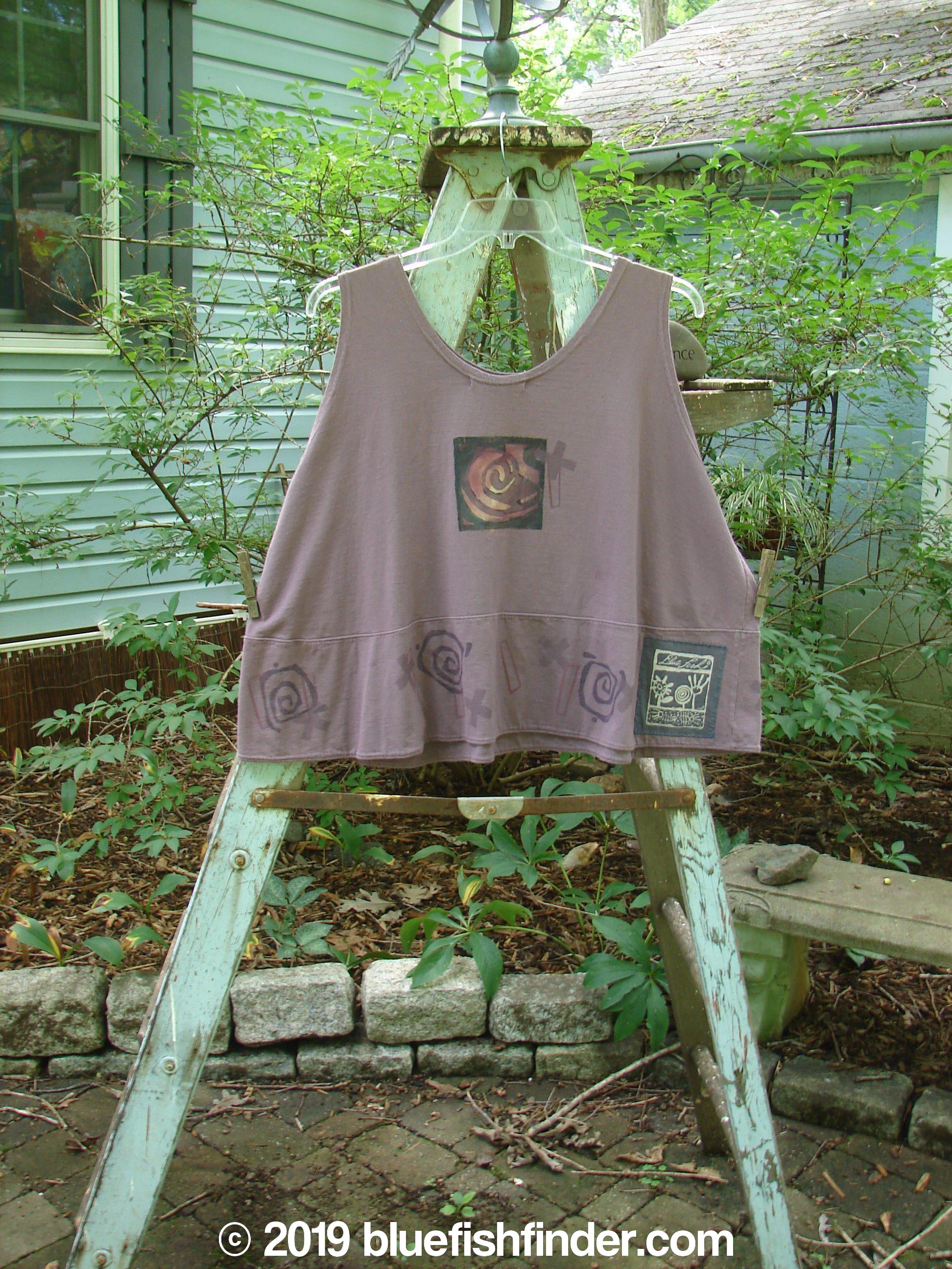 1995 Klee Button Top Cathedral Madder Lake Size 2: A swingy purple shirt on a wooden ladder, with a close-up of a painting and a sign.