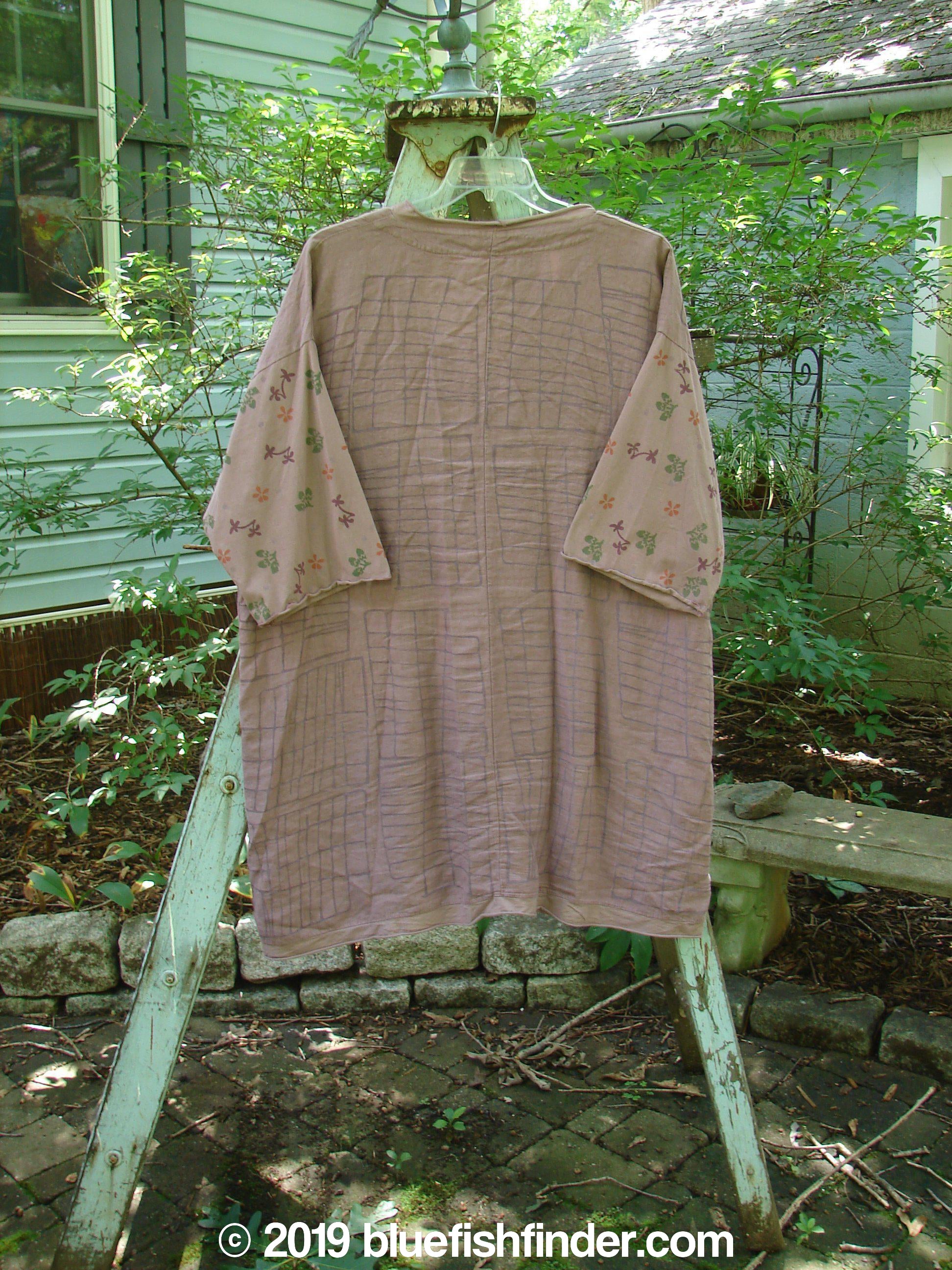 Barclay Linen Cotton Sleeve Pocket Cardigan Rich Mauve Size 0: A shirt on a swinger, with a long brown dress, a towel from a ladder, and a shirt on a rack.