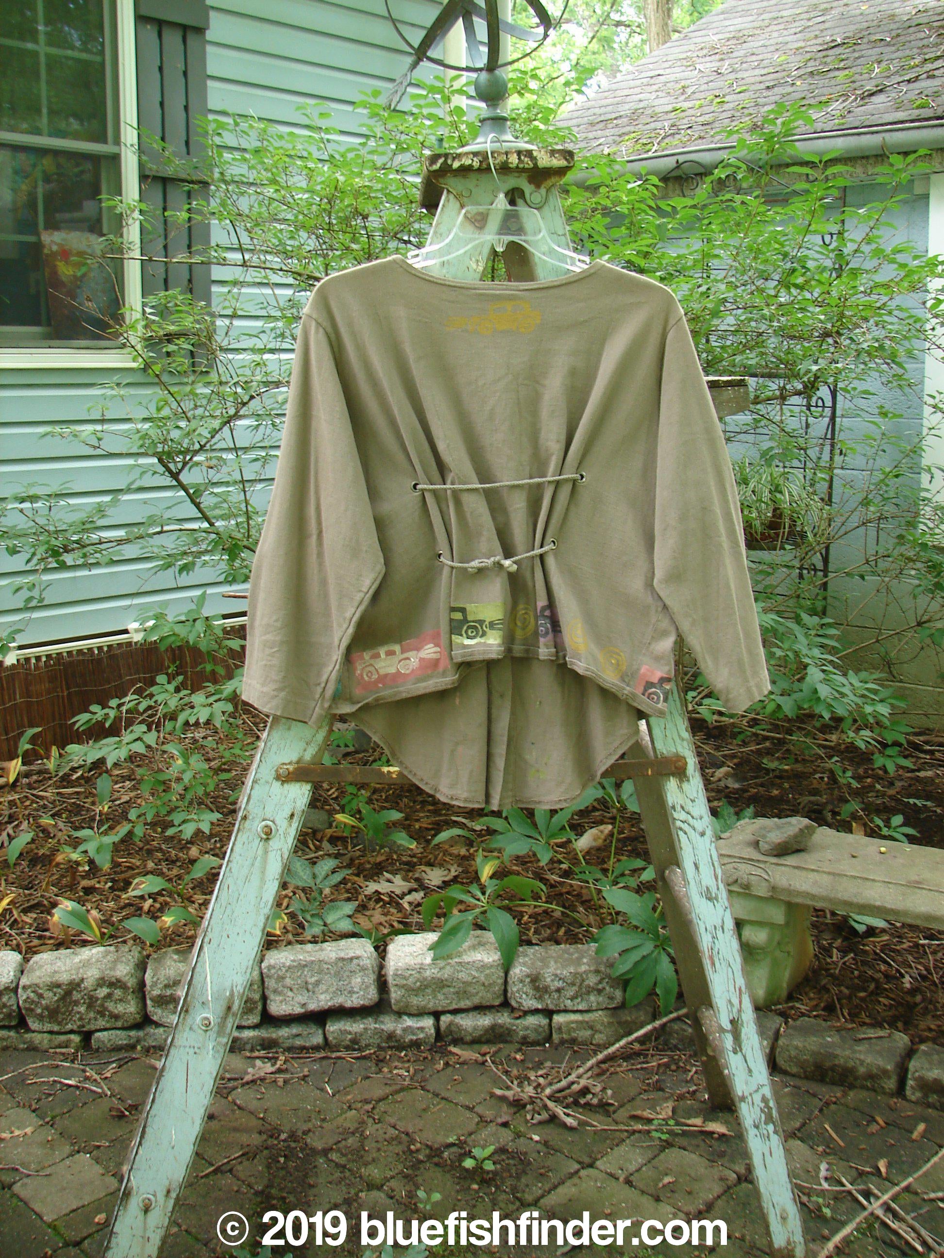 1993 Tie Back Jacket Car Bay Leaf OSFA: A mid-weight cotton jacket with a vintage car theme paint. Features include a top vintage button, original buttons, drop shoulders, and varying front and back hemline. Perfect condition. Bust 56, waist 57, hips 60. Front length 30, back length 19, sides 22 inches.