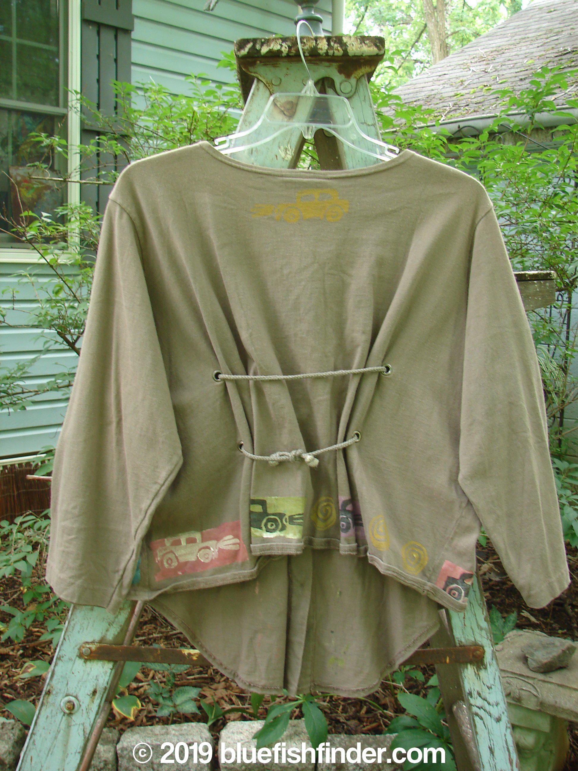 Image alt text: 1993 Tie Back Jacket featuring a shirt with a tie on a swinger, vintage buttons, drop shoulders, and a unique antique car theme paint.